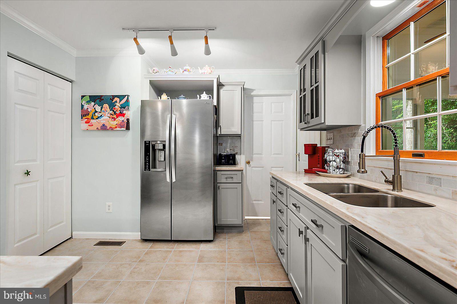 101 Sandyhook Road Ocean Pines, MD 21811 - Photo 15 of 64 a kitchen with stainless steel appliances granite countertop a sink and a refrigerator