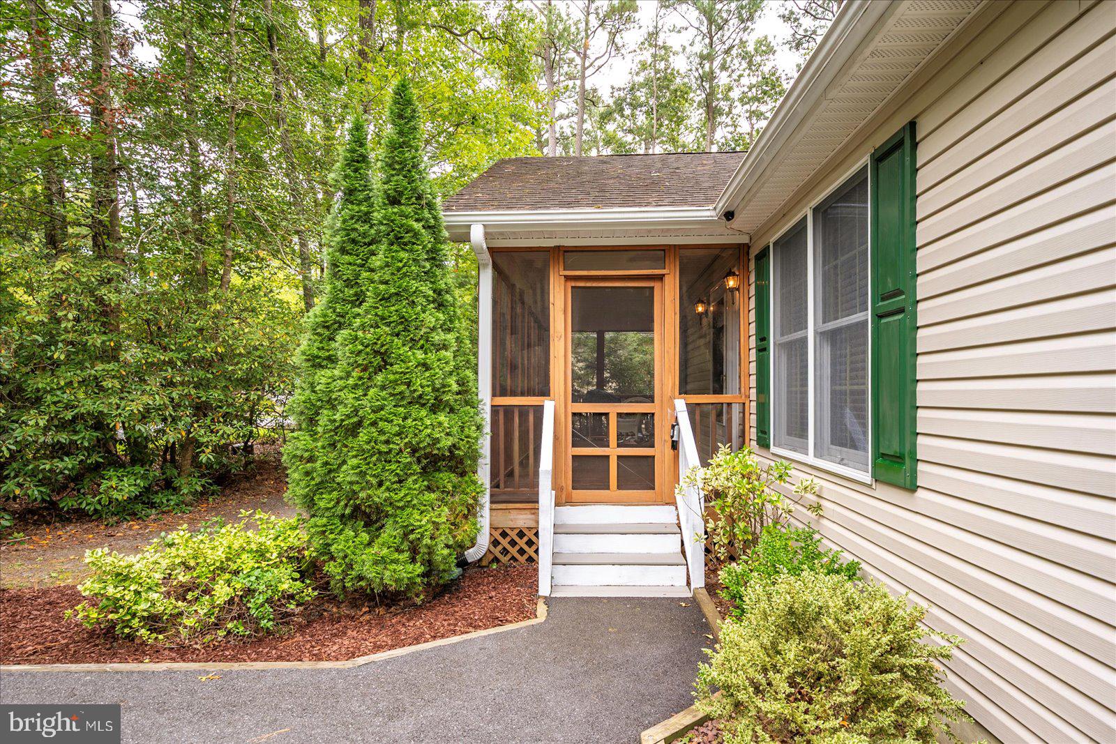 101 Sandyhook Road Ocean Pines, MD 21811 - Photo 4 of 64 a front view of a house with a yard