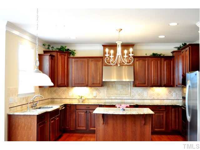 508 Elan Hall Road Cary, NC 27519 - Photo 6 of 17 Custom ordered granite with curves ordered after closing and tile backsplash installed by professionally company