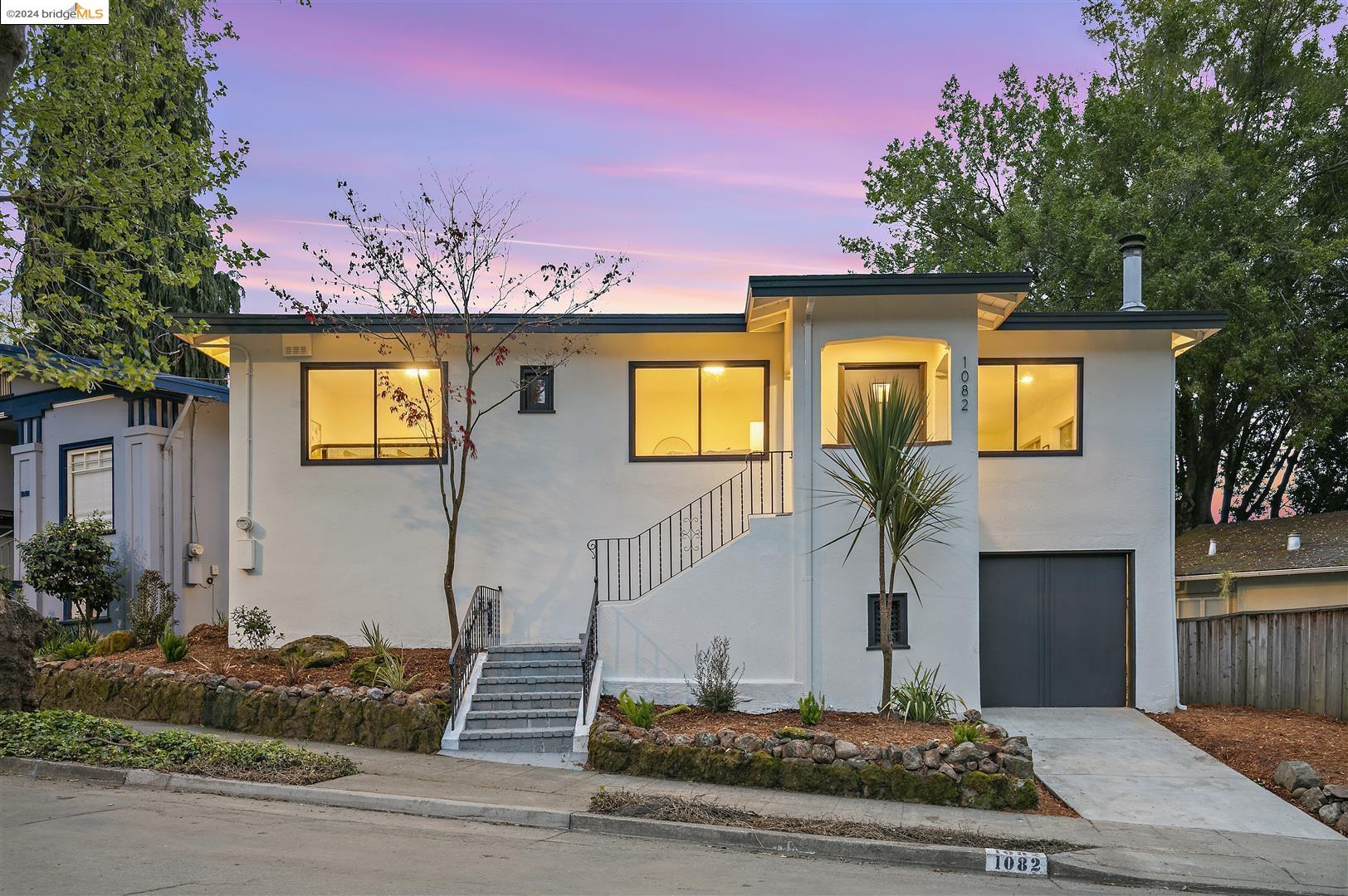 a front view of a house with trees