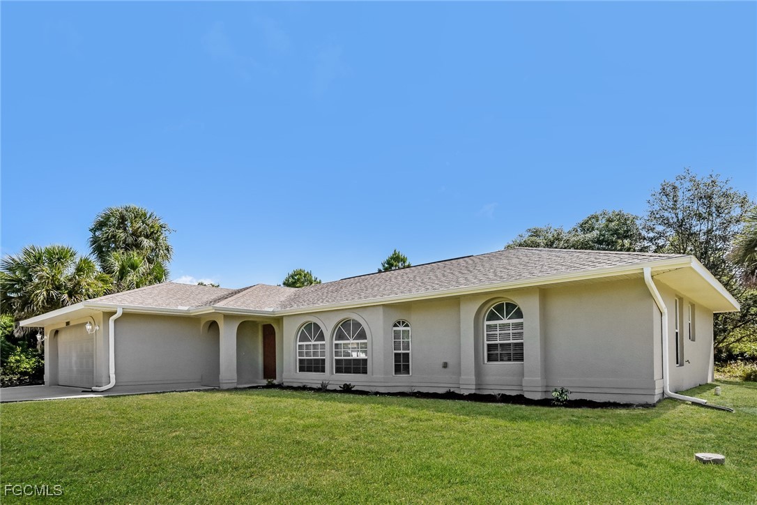 2810 Beloit Terrace North Port, FL 34286 - Photo 2 of 16 a front view of house with yard and trees in the background
