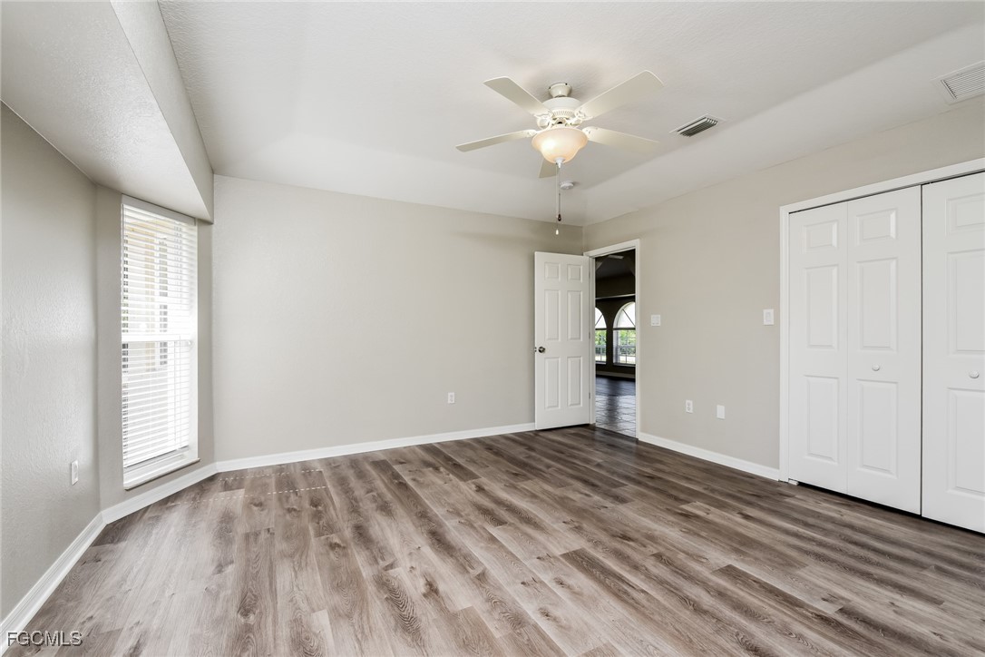 2810 Beloit Terrace North Port, FL 34286 - Photo 10 of 16 wooden floor in an empty room with a window