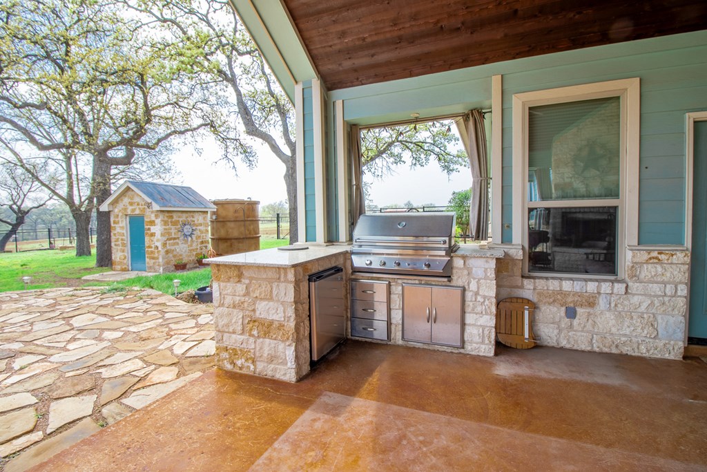 6515 Highway 27 Center Point, TX 78010 - Photo 24 of 48 a view of a house with a backyard and a patio
