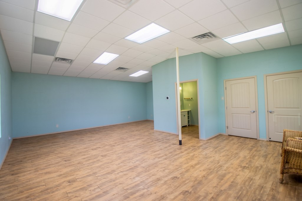 6515 Highway 27 Center Point, TX 78010 - Photo 41 of 48 an empty room with wooden floor and windows