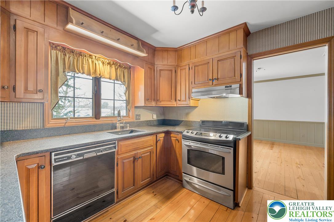 904 Parkway Road Allentown, PA 18104 - Photo 11 of 42 a kitchen with granite countertop stainless steel appliances a stove sink and cabinets