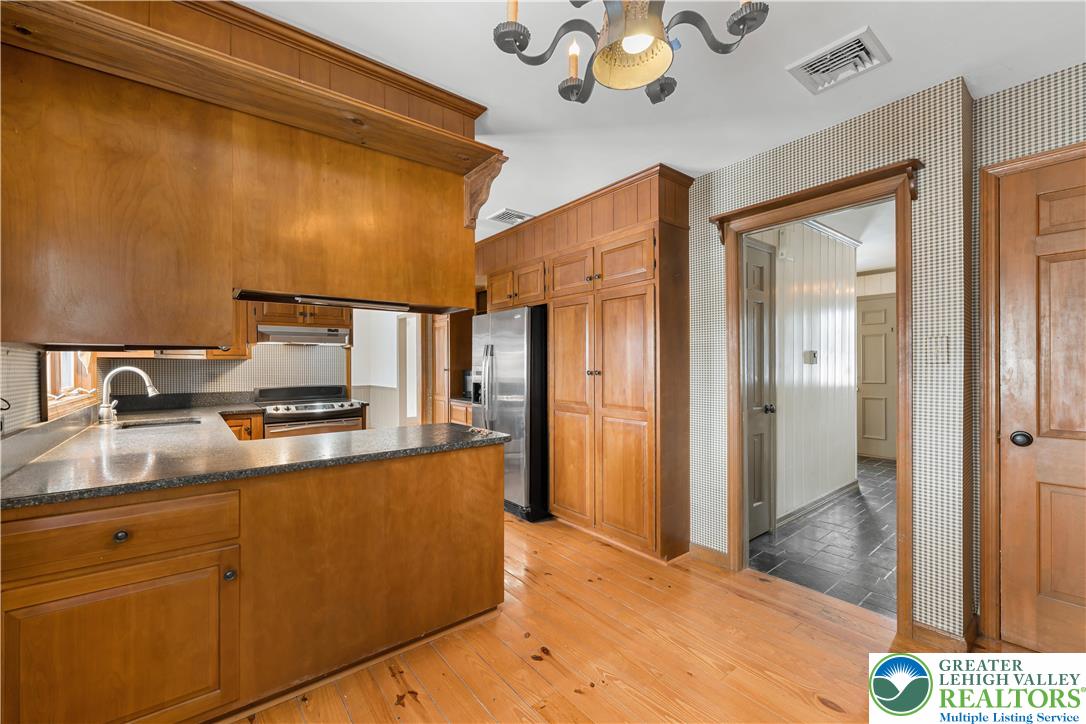 904 Parkway Road Allentown, PA 18104 - Photo 13 of 42 a kitchen with stainless steel appliances granite countertop a sink refrigerator and cabinets