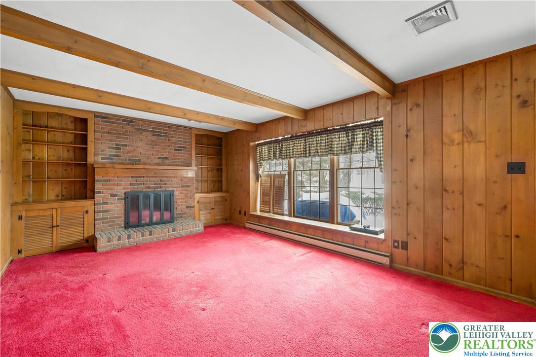 904 Parkway Road Allentown, PA 18104 - Photo 14 of 42 a view of an empty room with a fireplace and a window