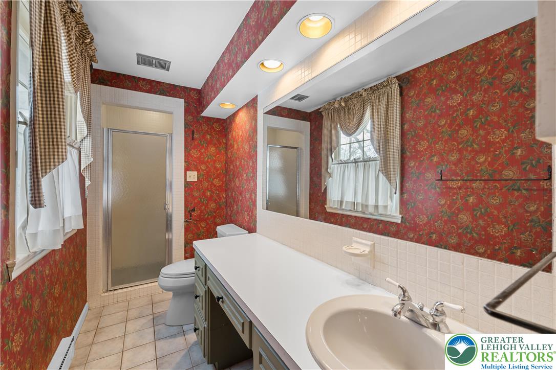 904 Parkway Road Allentown, PA 18104 - Photo 21 of 42 a bathroom with a sink and a mirror