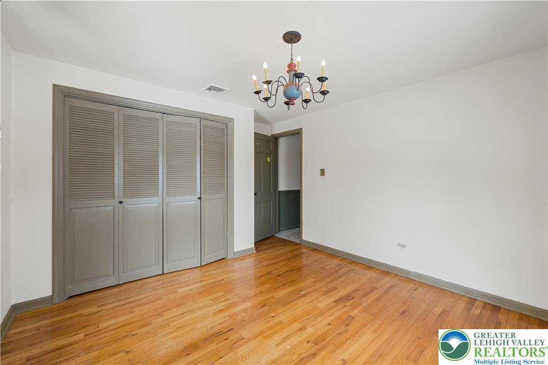 904 Parkway Road Allentown, PA 18104 - Photo 29 of 42 a view of a room with wooden floor and chandelier