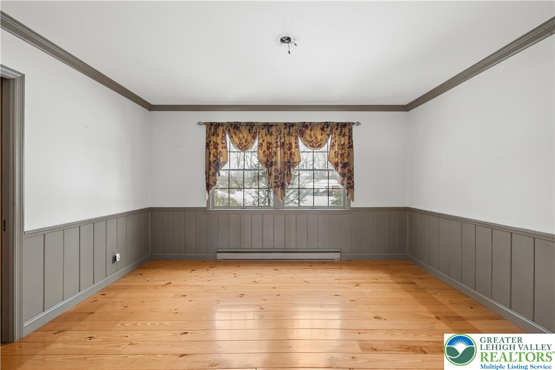 904 Parkway Road Allentown, PA 18104 - Photo 6 of 42 an empty room with wooden floor and windows