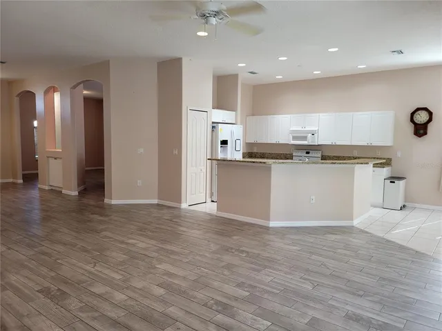 an entryway with wooden floor and cabinet