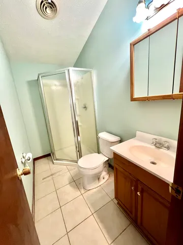 a bathroom with a toilet a sink and a mirror