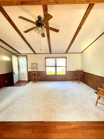 a view of a room with furniture and a ceiling fan