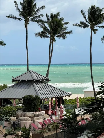 a view of a patio with table and chairs potted plants