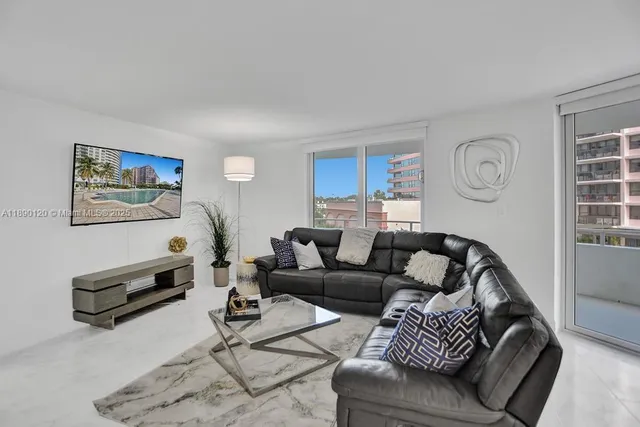 a living room with furniture a rug and a window