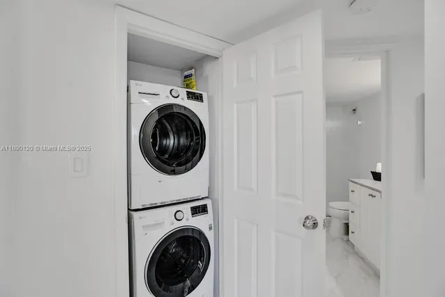 a view of a hallway with washer and dryer