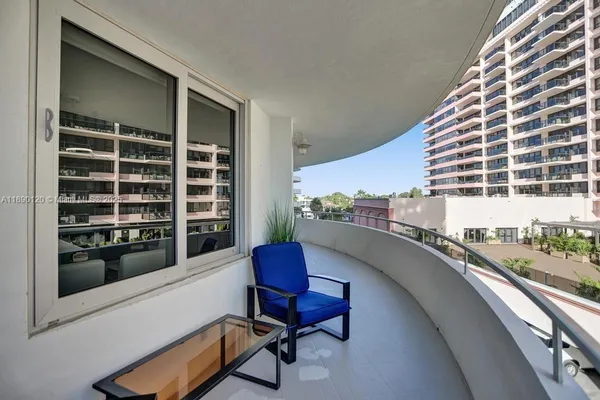 a balcony with table and chairs