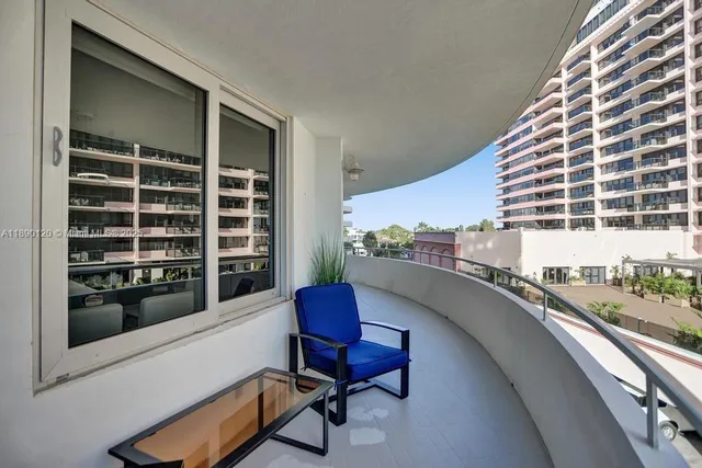 a balcony with table and chairs