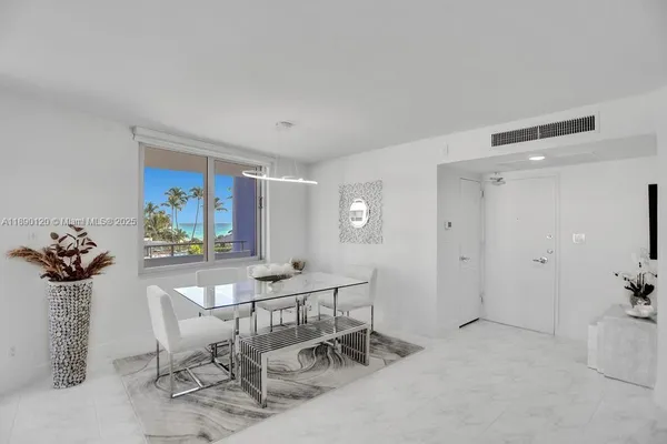 a view of a livingroom with furniture and a potted plant