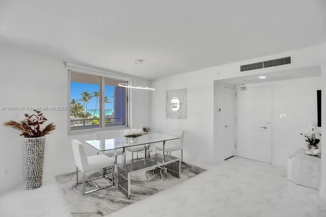 a view of a livingroom with furniture and a potted plant