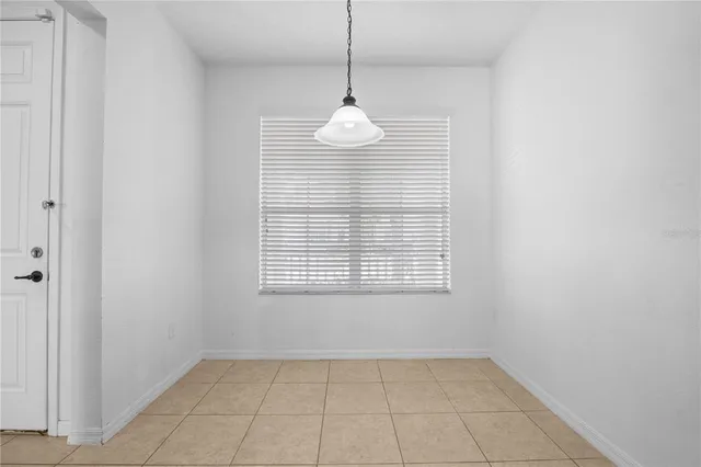 a view of a big room with windows and chandelier fan