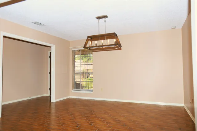 a view of a room with wooden floor and windows