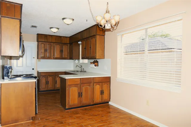 a kitchen with a sink stove and cabinets