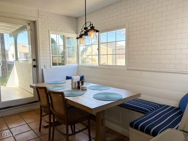 a view of a hallway view of wooden floor and a bathroom