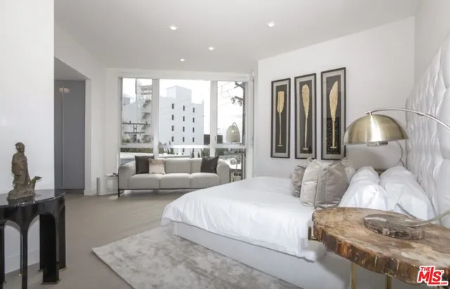 a bedroom with a large bed and a large window