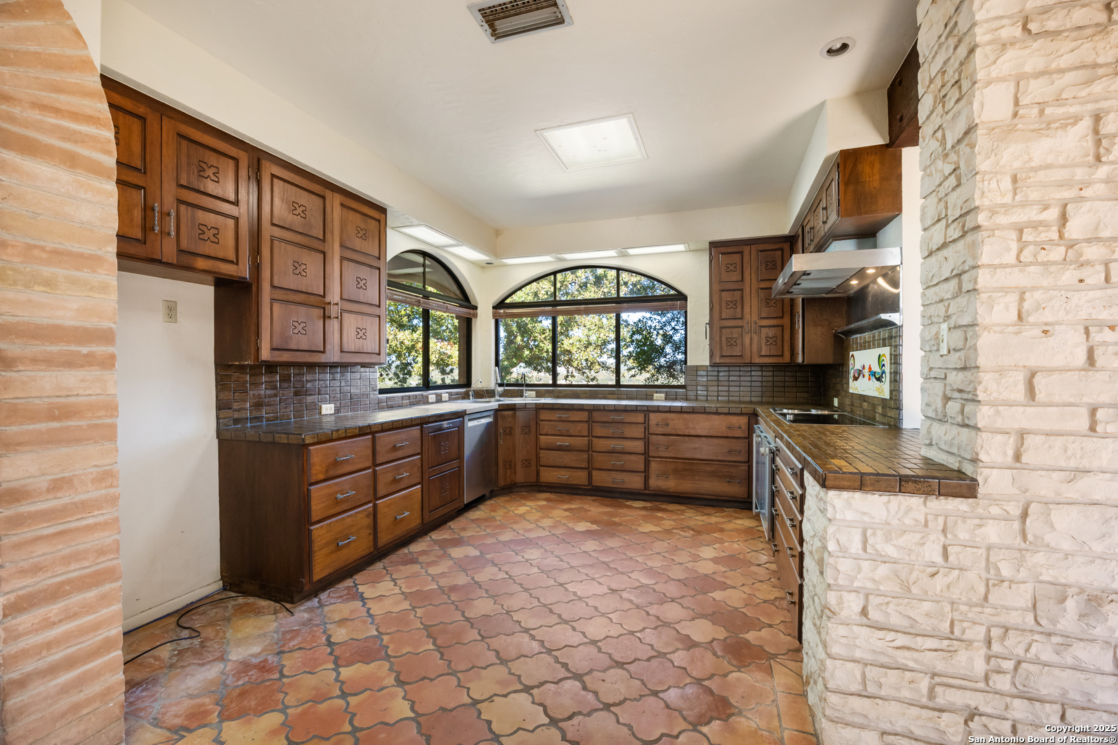2650 Bandera Highway Kerrville, TX 78028 - Photo 24 of 50 a kitchen with stainless steel appliances granite countertop a stove and cabinets