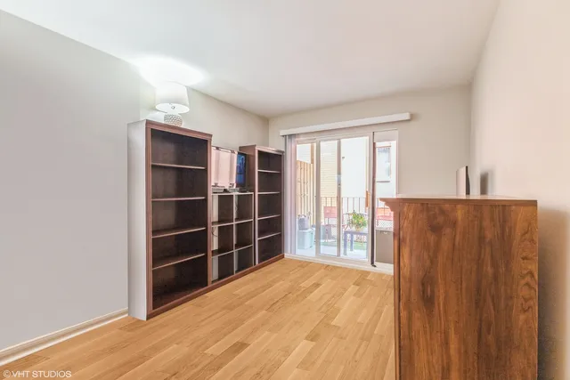 a view of wooden floor and windows in a room