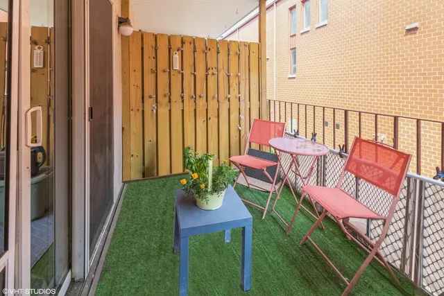 a balcony with chairs and a table