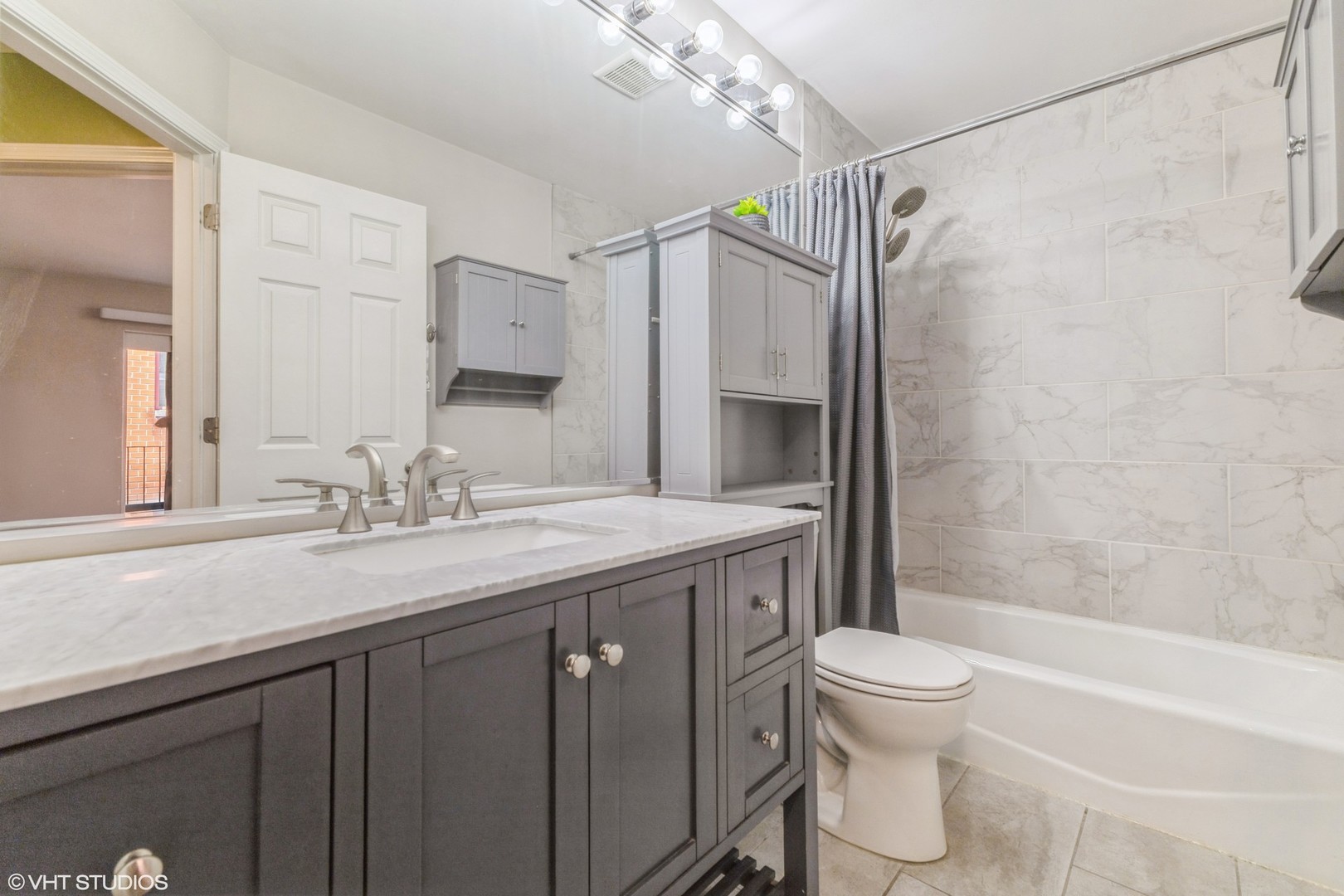 1328 South Federal Street, Unit G Chicago, IL 60605 - Photo 15 of 27 a bathroom with a granite countertop sink toilet and shower
