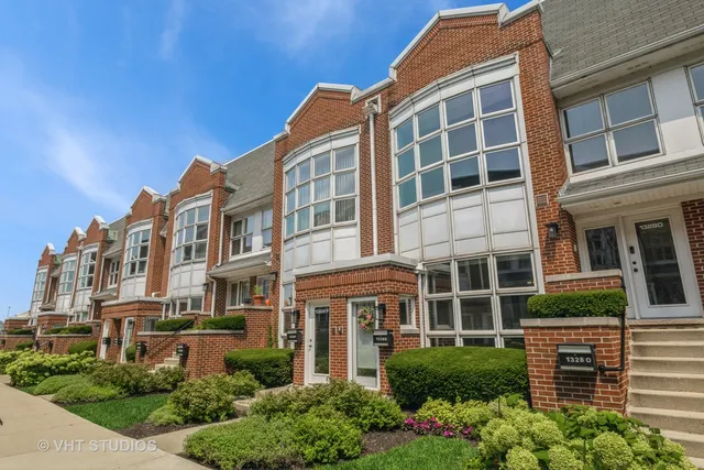 a front view of a building with a garden