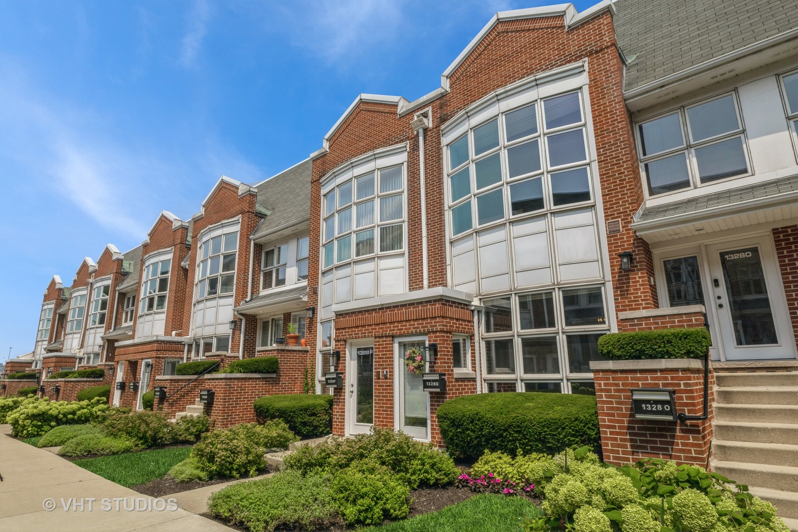 1328 South Federal Street, Unit G Chicago, IL 60605 - Photo 22 of 27 a front view of a building with a garden