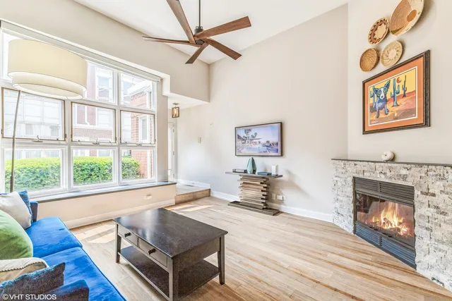 a living room with furniture large window and a fireplace