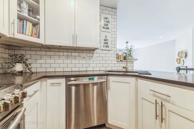 a kitchen with stainless steel appliances granite countertop a sink and cabinets