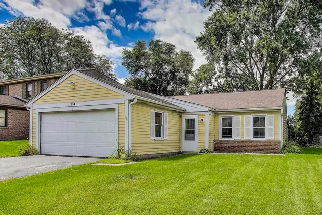 a view of backyard of house with green space