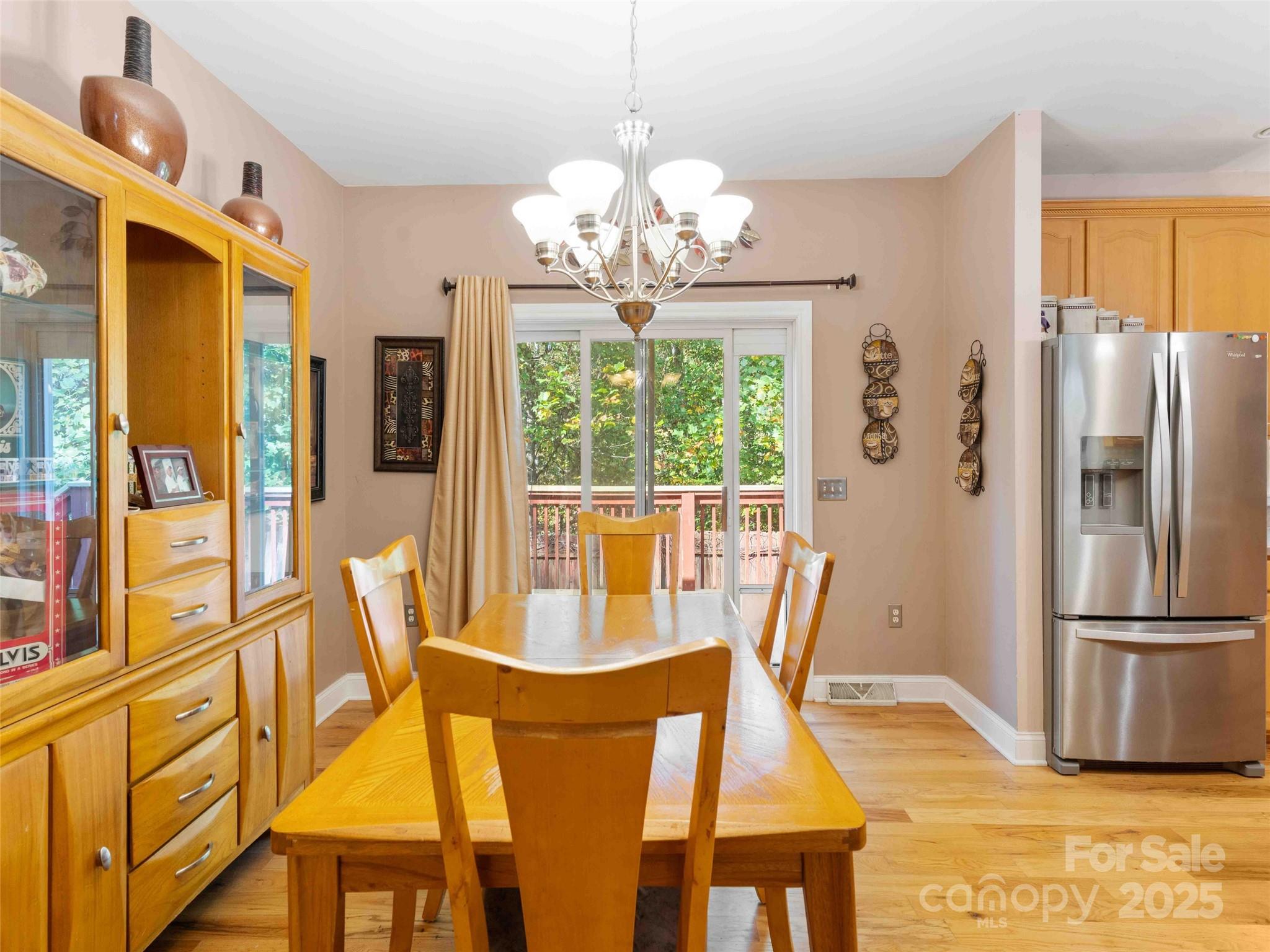 37 C Creek Lane Pisgah Forest, NC 28768 - Photo 26 of 34 a view of a dining room with furniture a chandelier and large window