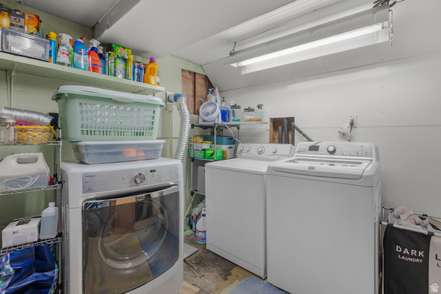 1275 North Geneva Road Provo, UT 84601 - Photo 22 of 25 Dedicated laundry area featuring a front-load dryer, top-load washing machine, and wall-mounted shelving