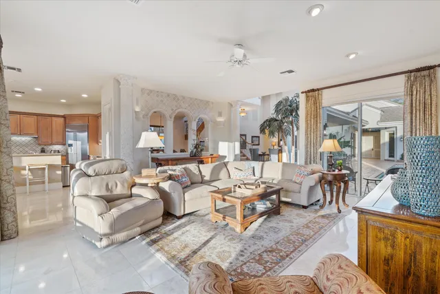 a kitchen with stainless steel appliances kitchen island granite countertop a table and chairs