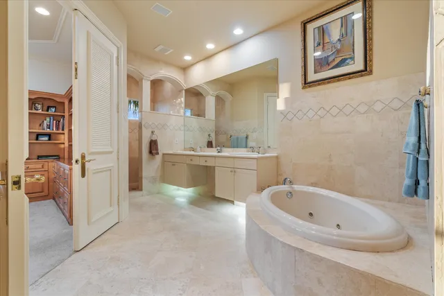 a bedroom with a large bed and a chandelier