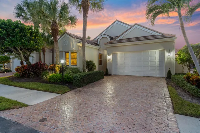 a view of a swimming pool with potted plants in front of house