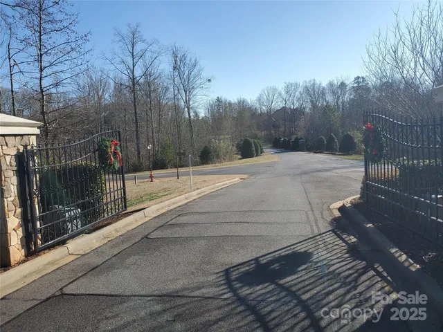 a view of a pathway with a wrought fence