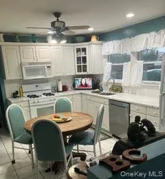 a kitchen with stainless steel appliances a stove a sink and cabinets