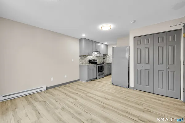 a view of a kitchen with a stove cabinets and wooden floor