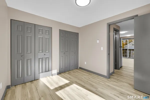 a view of a livingroom with wooden floor & cabinet