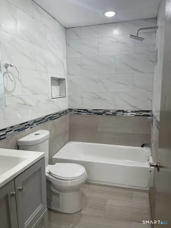 a bathroom with a toilet and a bathtub