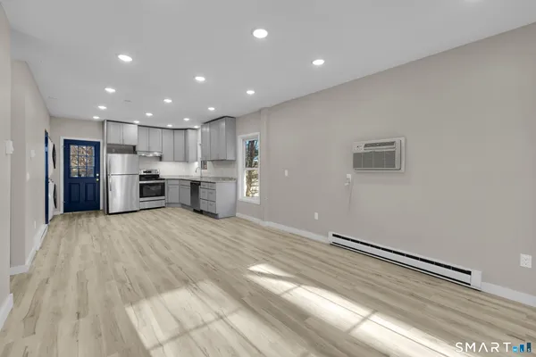a large kitchen with stainless steel appliances lots of counter space and a sink