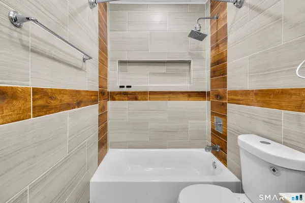 a bathroom with a bathtub and a toilet
